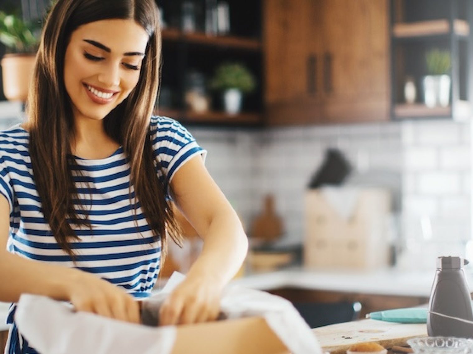 Woman arranging items in a box.