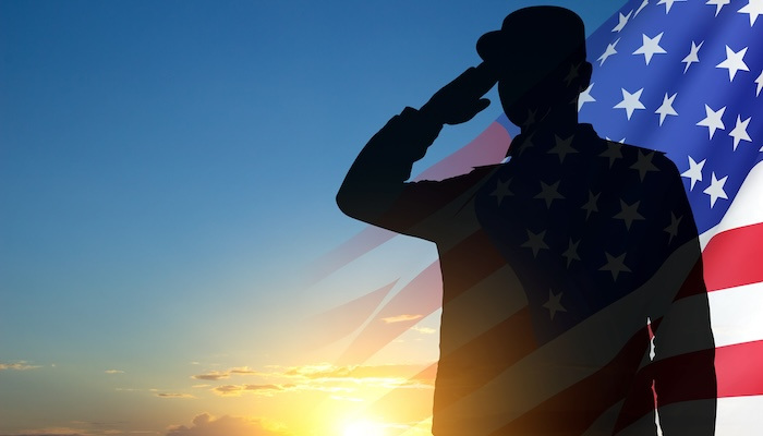 Silhouette of a man in front of an American flag.