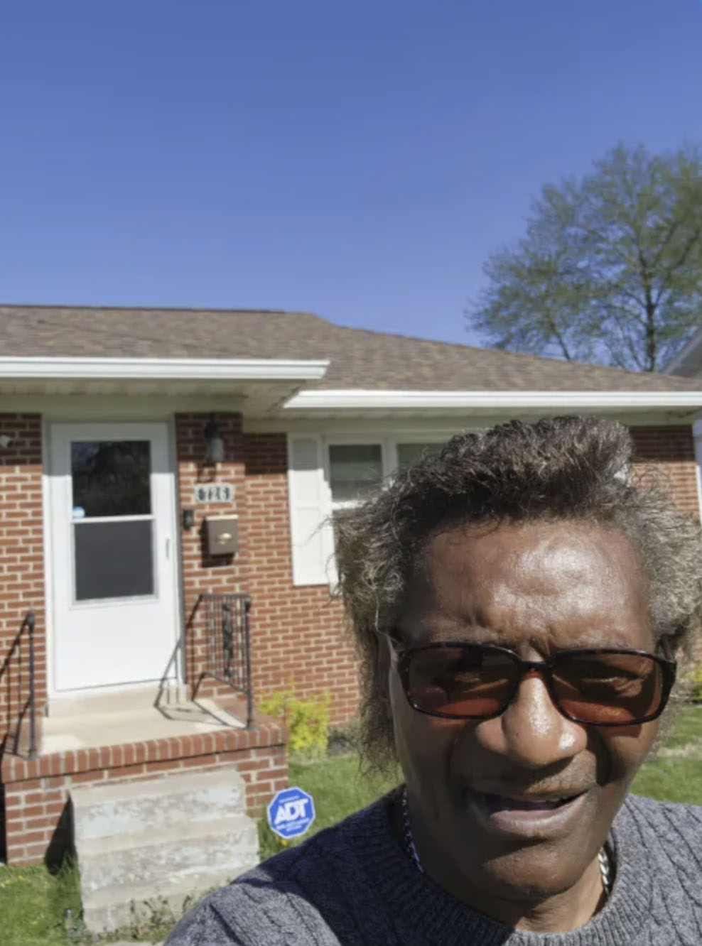 picture of Roosevelt L. in front of a house