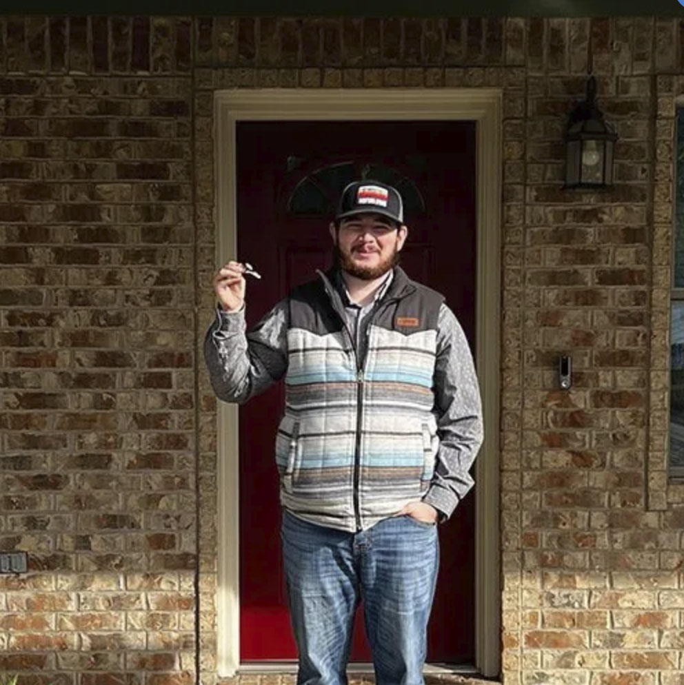 picture of Brett E. in front of a house