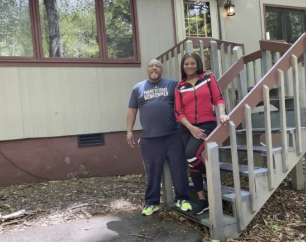 picture of Dormain V. in front of a house